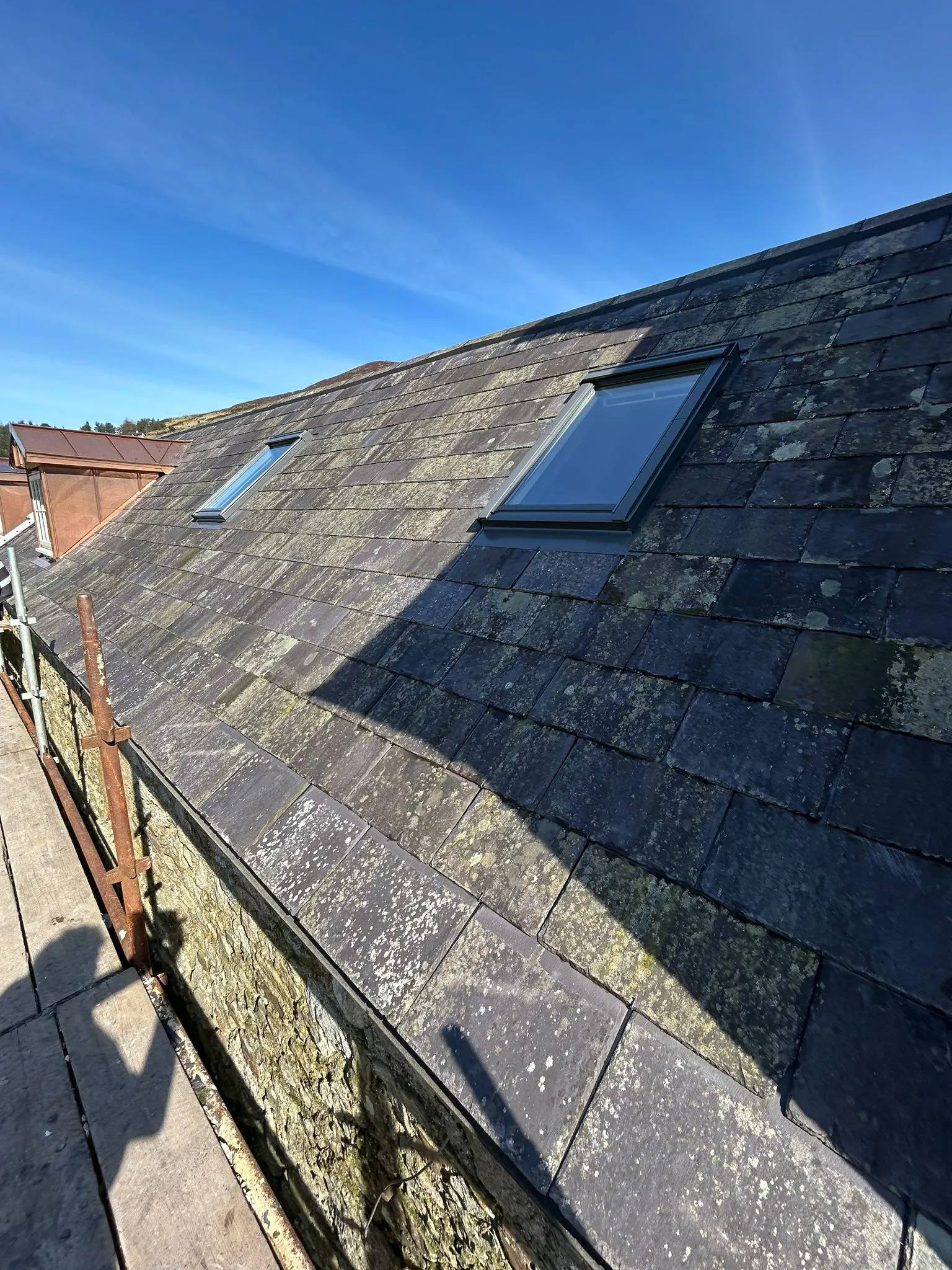 Existing slates being re-used on a farm roof — photo 1