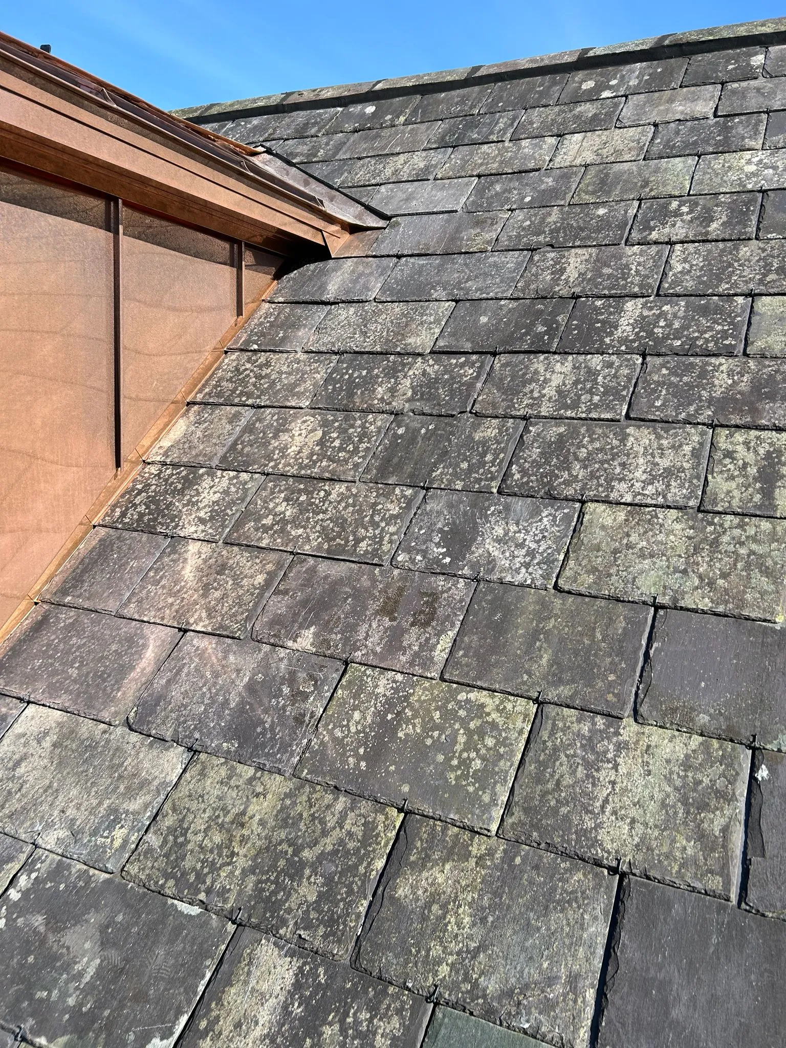 Existing slates being re-used on a farm roof — photo 3