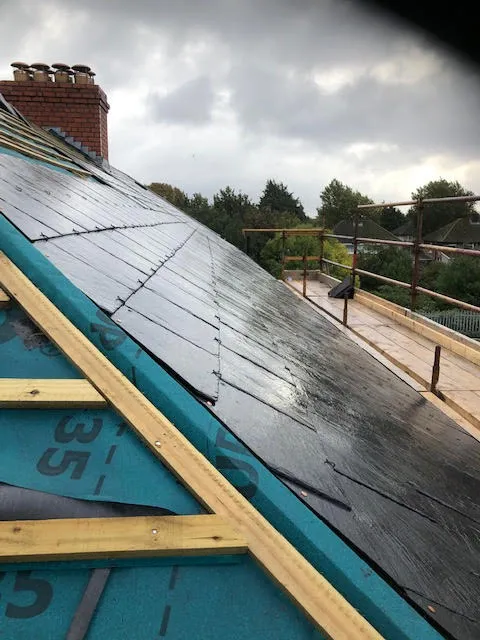 Roof being replaced. Existing Bangor slates on the front and side slopes. New Spanish slates on the back — photo 12